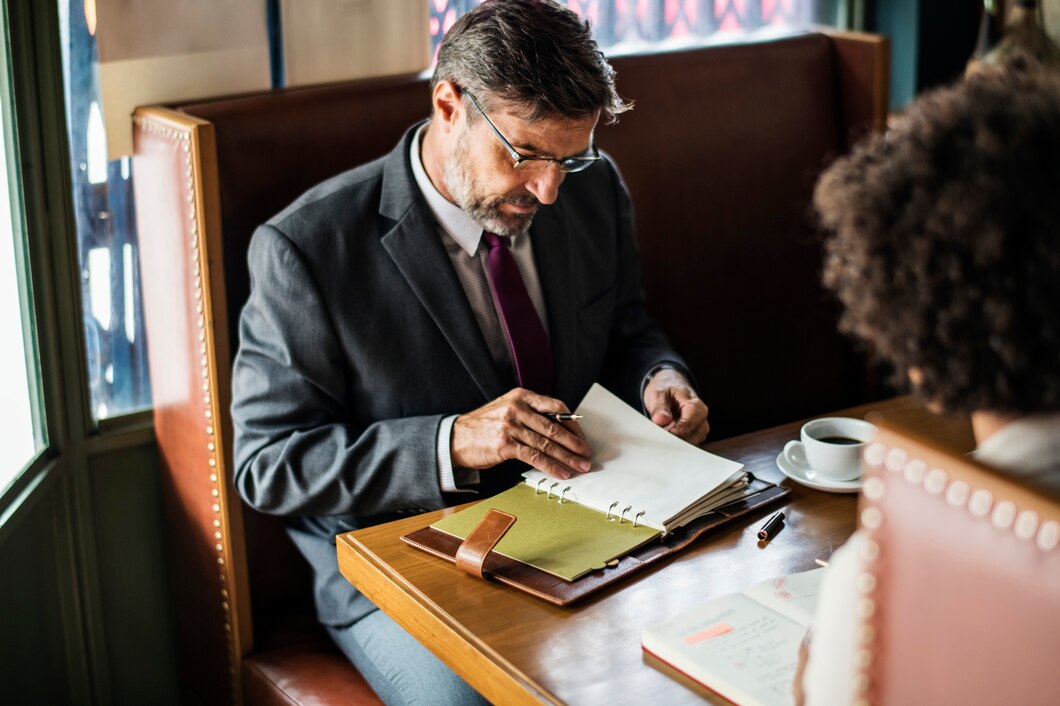 Business People discussing Legal Document in cafe 